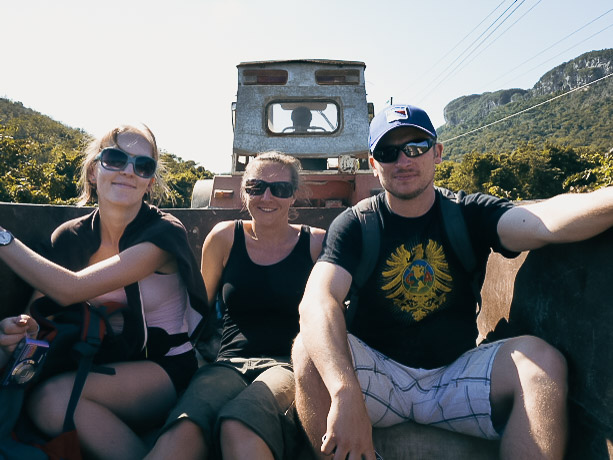 Three people in back of a tractor