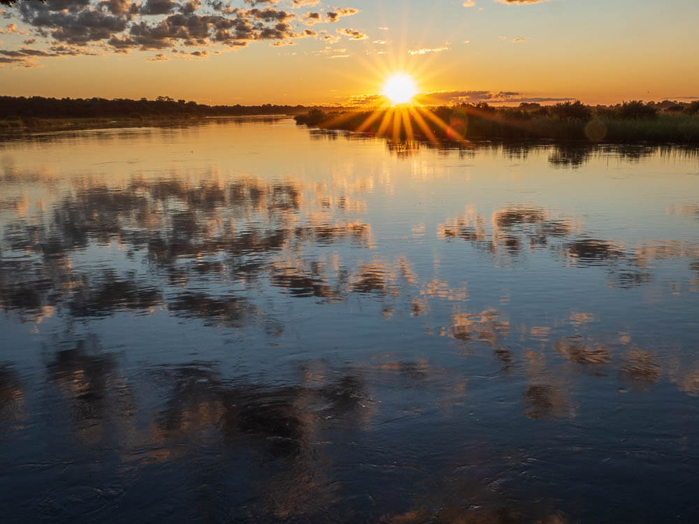 Sunset with sky reflected in Cubango River