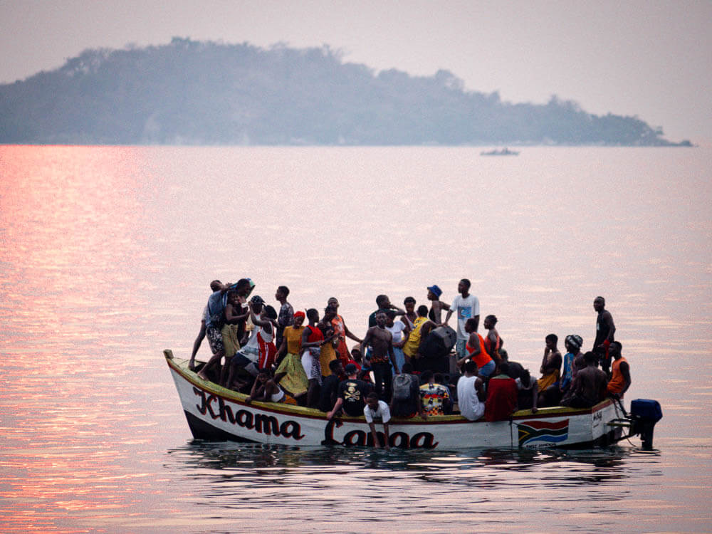 People dancing on a boat at sunset
